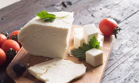 ingredients for greek salad on a wooden board