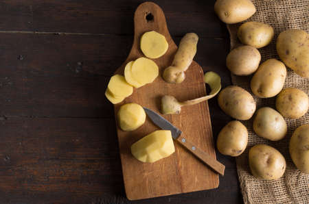 Fresh potatoes on an old wooden table