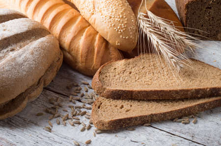 different types of bread on a wooden table