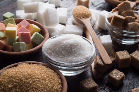 different types of sugar on wooden background