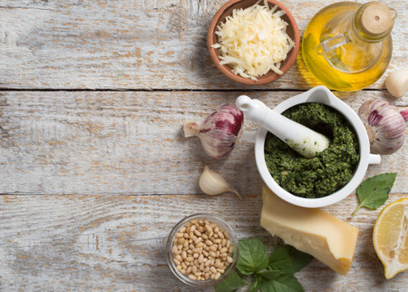Homemade basil pesto sauce with fresh ingredients.の写真素材