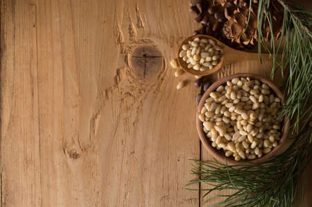 Cedar nuts and cones on wooden tableの写真素材