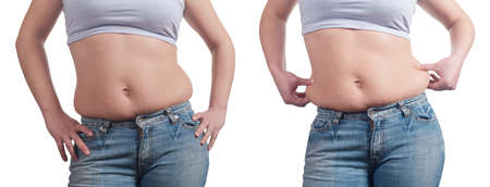 fat woman measuring her stomachの写真素材