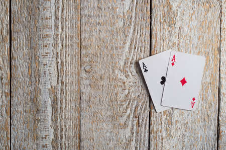Old playing cards on wooden backgroundの写真素材