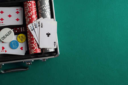 Poker chips in case on green tableの写真素材