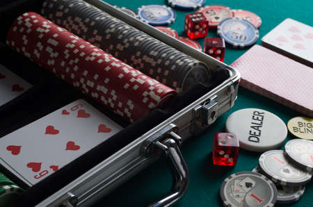 Poker chips in case on green tableの写真素材