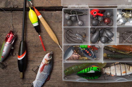 Accessories for fishing on the background of wood.の写真素材