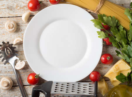 spaghetti and ingredients on wooden backgroundの写真素材