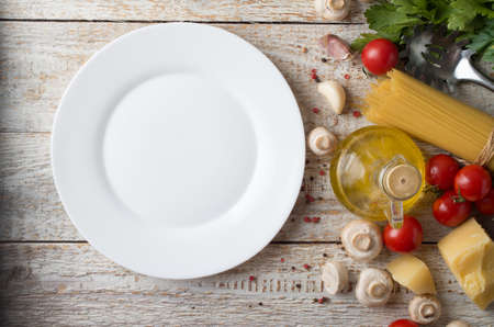 spaghetti and ingredients on wooden backgroundの写真素材
