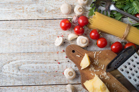 spaghetti and ingredients on wooden backgroundの写真素材