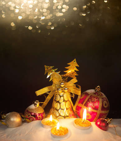 Burning candles in a Christmas setting with seasonal decorationsの写真素材