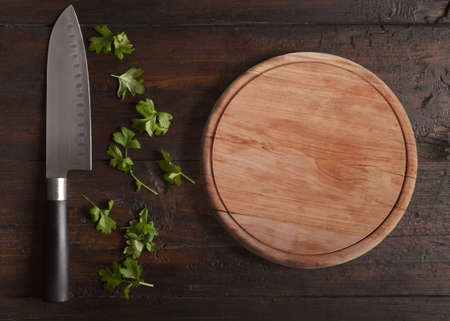 Parsley with knife on wooden tableの写真素材