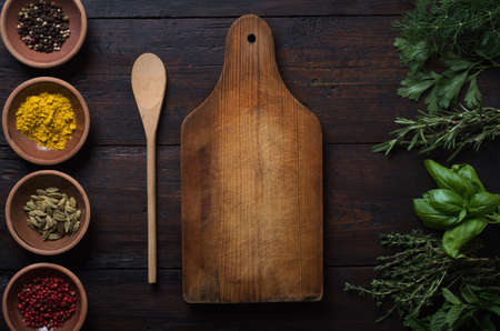 Fresh spices thyme, turmeric, cardamom, basil, mint, parsley, dill and rosemary on wooden background.の写真素材