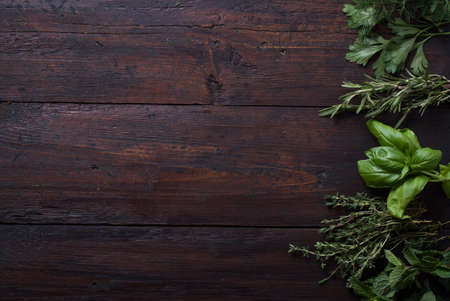 Fresh spices thyme, cardamom, basil, mint, parsley, dill and rosemary on wooden background.の写真素材