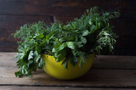 Fresh spices thyme, cardamom, basil, mint, parsley, dill and rosemary on wooden background.の写真素材
