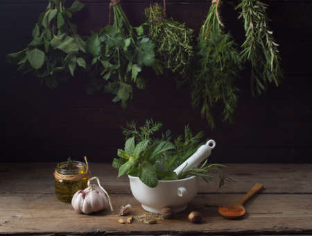 Fresh spices thyme, turmeric, cardamom, basil, mint, parsley, dill and rosemary on wooden background.の写真素材