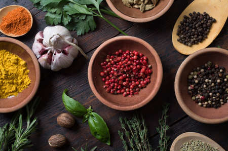 Fresh spices thyme, turmeric, cardamom, basil, mint, parsley, dill and rosemary on wooden background.の写真素材