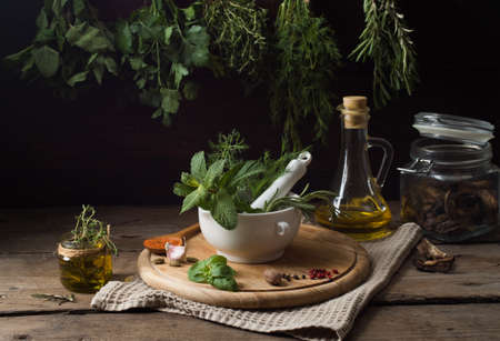 Fresh spices thyme, turmeric, cardamom, basil, mint, parsley, dill and rosemary on wooden background.の写真素材