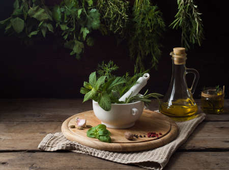 Fresh spices thyme, turmeric, cardamom, basil, mint, parsley, dill and rosemary on wooden background.の写真素材