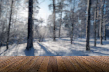 wood background against the background of the winter forestの写真素材