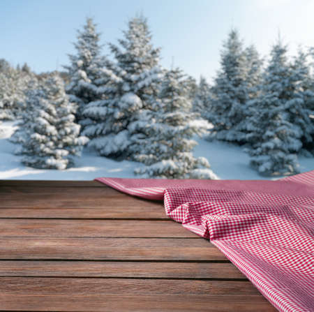 tablecloth on wooden table against the background of the winter forestの写真素材