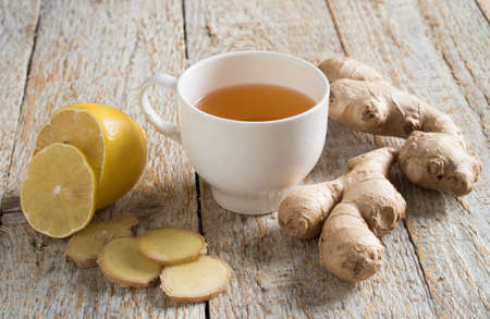 Ginger tea with lemon on a wooden tableの写真素材