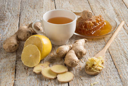 Ginger tea with lemon on a wooden tableの写真素材