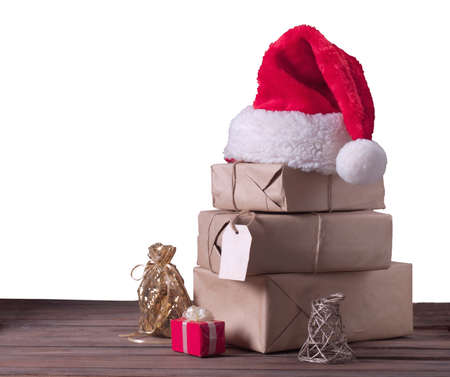 boxes with Christmas presents and santa hat isolated on a white backgroundの写真素材