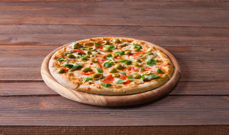 Hot pizza on wooden tableの写真素材