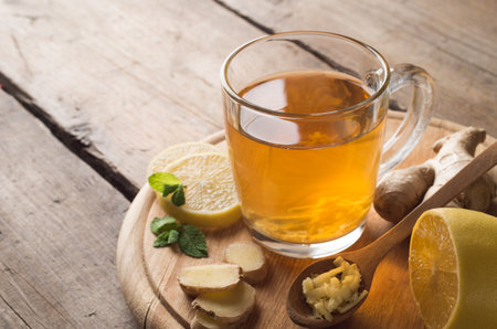Ginger tea with lemon on a wooden tableの写真素材