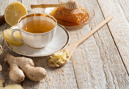 Ginger tea with lemon on a wooden tableの写真素材