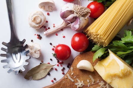 spaghetti and ingredients on a white backgroundの写真素材