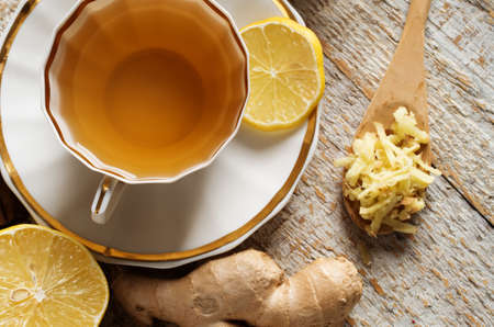 Ginger tea with lemon on a wooden tableの写真素材