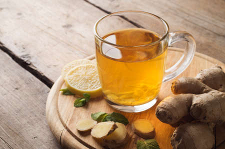 Ginger tea with lemon on a wooden tableの写真素材