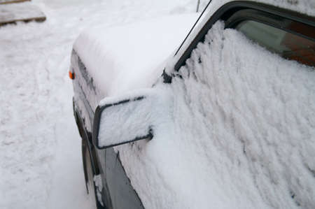 Car covered with fresh snowの写真素材