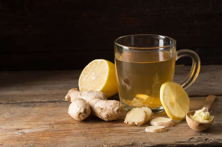 Ginger tea with lemon on a wooden tableの写真素材