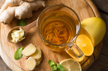 Ginger tea with lemon on a wooden tableの写真素材