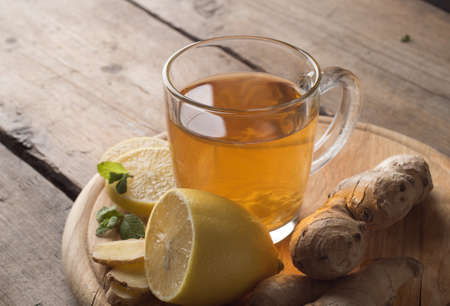 Ginger tea with lemon on a wooden tableの写真素材