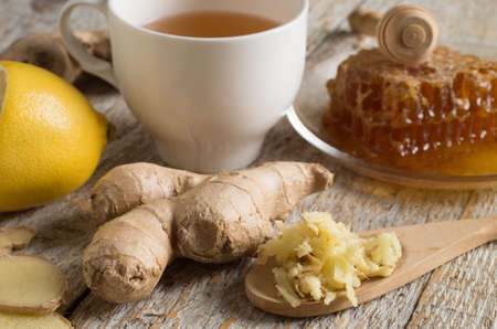 Ginger tea with lemon on a wooden tableの写真素材