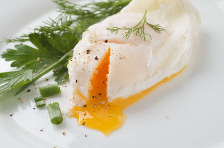 Poached eggs on white plateの写真素材