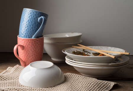 dirty dishes on a wooden tableの写真素材