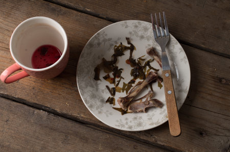 dirty dishes on a wooden tableの写真素材