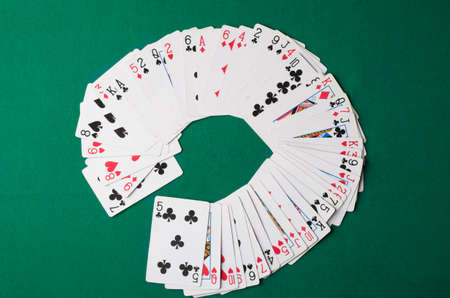 Cards on green felt casino table background.の写真素材