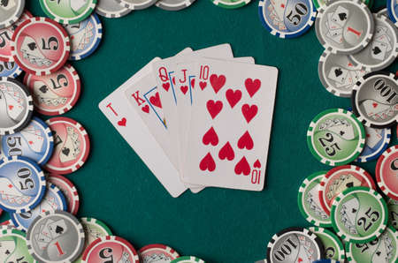 Cards on green felt casino table background.