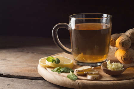 Ginger tea with lemon on a wooden table