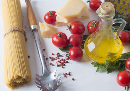 spaghetti and ingredients on a white backgroundの写真素材