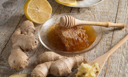 Honey, lemon and ginger on old wooden tableの写真素材