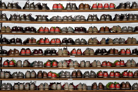 A rack full of different colors and size bowling shoesの写真素材