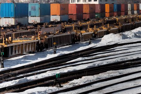 Industrial railway terminal in winter with container carrier wagons, rails and switchsのeditorial素材