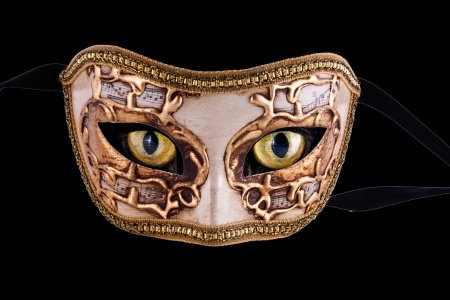 A beautiful venetian mask with music theme and cat eyes isolated in blackの写真素材
